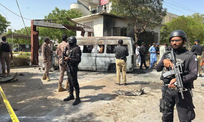 Security Personnel stand guard at the blast site in Karachi, Pakistan on Tuesday