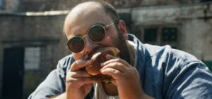 eating disorder man eating burger