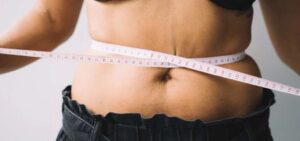 eating disorder measuring waist with tape