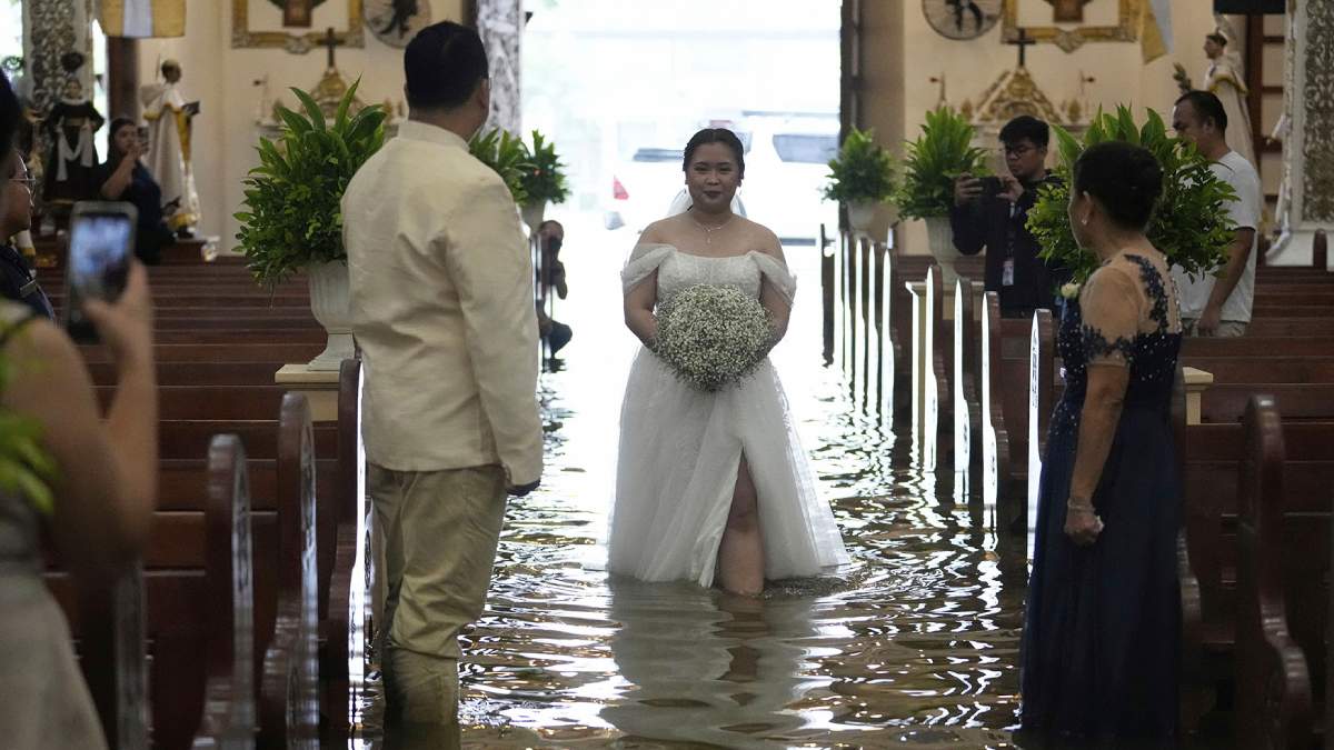 Filipino couple wedding flooded church, Barasoain Church flooded wedding, Typhoon Wipha Philippines wedding,